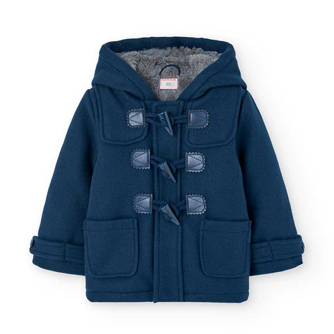 Giacca Montgomery con cappuccio per bambino, colore blu, tasconi sul davanti.