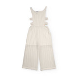 Tuta bianca per bambina con tagli laterali e design elegante.