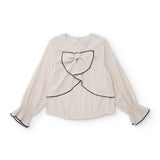 Blusa panna con grande fiocco frontale e bordi neri, maniche lunghe arricciate