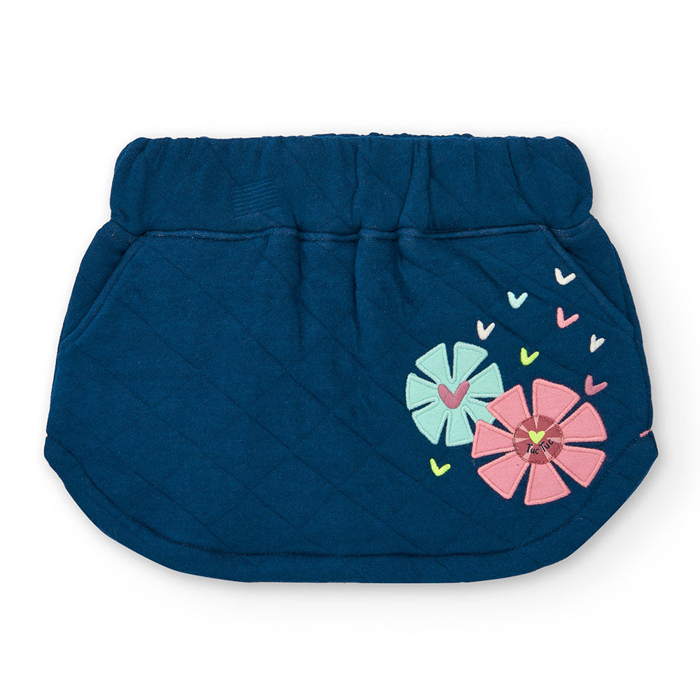 Mini skirt from the Tuc Tuc Girls' Clothing Line, quilted with an appliqued flower on one side. 
...