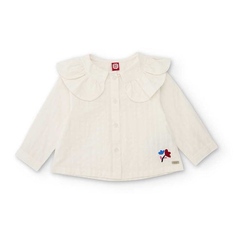 Camicia bianca per bambina con colletto arricciato e piccoli dettagli colorati vicino all'orlo