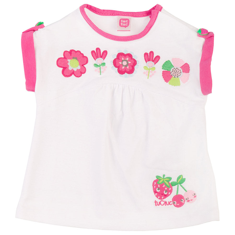 
  T-shirts from the Tuc Tuc girl's clothing line, with buttoned-up dummies
  and colored embroid...
